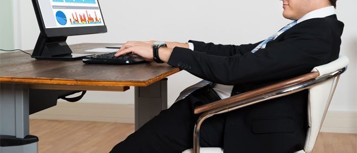 man with bad posture sitting at desk
