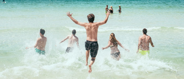 people jumping into ocean